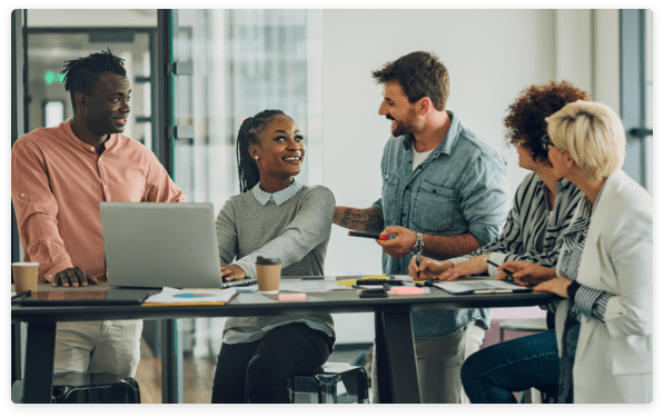 Professional people collaborating around a tall table