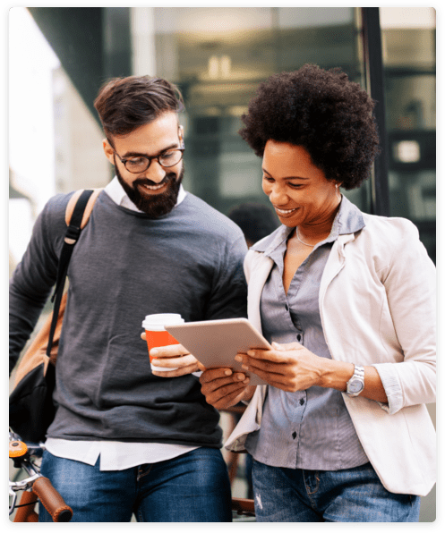 Rethink-Recruitment-Image Two people looking at a tablet outside a glass building